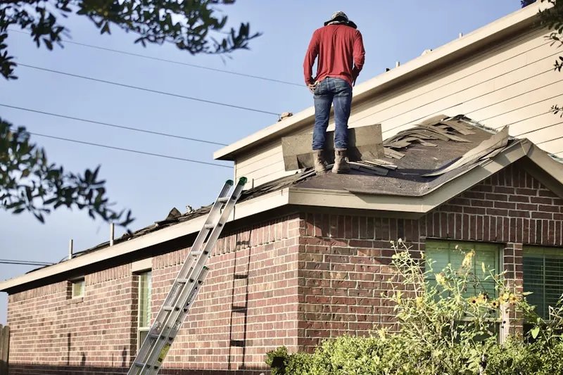 Professional roofer working on a residential roof in Wantagh